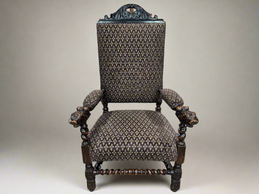 Carved oak antique arm chair with fleur de lis upholstery